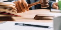 Judge striking gavel with open law book Judge striking gavel with open law book