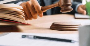 Judge striking gavel with open law book Judge striking gavel with open law book