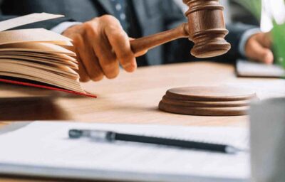 Judge striking gavel with open law book Judge striking gavel with open law book