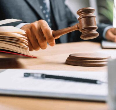 Judge striking gavel with open law book Judge striking gavel with open law book